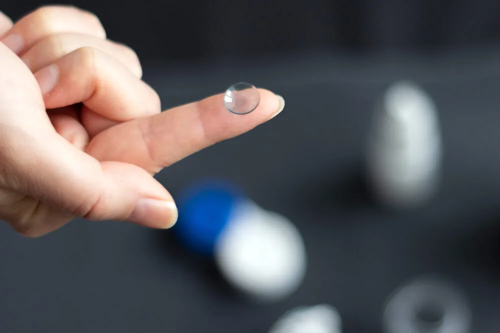 Orthokeratology contact lens on a fingertip
