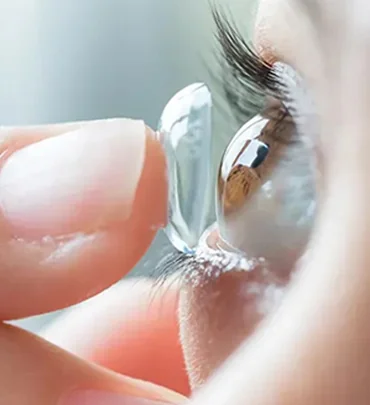 Contact lens held near an eye